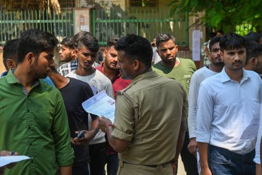 NOIDA INDIA AUGUST 30 2024 Aspirants appearing for the UP Police Constable Re Exam 2024 are frisked and their documents are verified by police personnel at Rajkiya Balika Inter College sector 51 on August 30 2024 in Noida India Photo by Sunil Ghosh H clipart