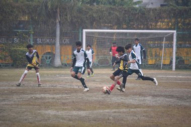 GURUGRAM INDIA FEBRUARY 4 2024 Students of DPS Vasant Kunj Yellow Jersey and DPS Sushant Lok White Jersey playing the football match for third position during the Maharaj Hari Singh Memorial Football Tournament 30 in DPS Sushant Lok near Millennium P clipart