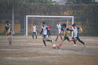 GURUGRAM INDIA FEBRUARY 4 2024 Students of DPS Vasant Kunj Yellow Jersey and DPS Sushant Lok White Jersey playing the football match for third position during the Maharaj Hari Singh Memorial Football Tournament 30 in DPS Sushant Lok near Millennium P clipart