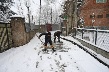 SRINAGAR INDIA FEBRUARY 4 2024 Municipal workers are seen clearing snow road on February 4 2024 in Srinagar India Several parts of Kashmir including Srinagar city witnessed fresh snowfall as the MeT department has forecast moderate topheavy snowfall  clipart