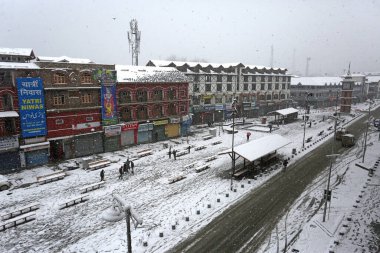 SRINAGAR INDIA FEBRUARY 4 2024 A view of the Lal Chowk Ghanta Ghar during a snowfall on February 4 2024 in Srinagar India Several parts of Kashmir including Srinagar city witnessed fresh snowfall as the MeT department has forecast moderate topheavy s clipart