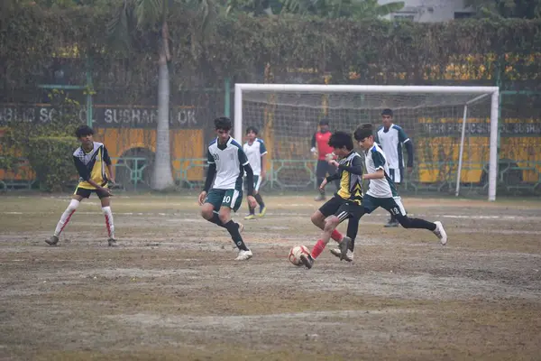 stock image GURUGRAM INDIA FEBRUARY 4 2024 Students of DPS Vasant Kunj Yellow Jersey and DPS Sushant Lok White Jersey playing the football match for third position during the Maharaj Hari Singh Memorial Football Tournament 30 in DPS Sushant Lok near Millennium P