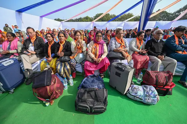 stock image NEW DELHI INDIA FEBRUARY 5 2024 Senior citizens who are departing for Tirupati Balaji on the 89th train under Mukhyamantri Teerth Yatra Yojana interacting with Arvind Kejriwal Chief Minister of Delhi during an event at Thyagraj Stadium on February 5 