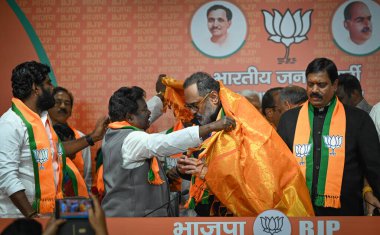 NEW DELHI INDIA FEBRUARY 7 2024 BJP Leader Rajeev Chandrasekhar issues the joining certificates to the Ex MLAs and leaders from AIDMK DMK Congress and other parties from Tamil Nadu who joins BJP at BJP Headquarters DDU Marg on February 7 2024 in New  clipart