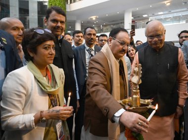 NEW DELHI INDIA FEBRUARY 9 2024 BJP National President JP Nadda along with Chairman Rambhau Mhalgi Prabodhini  Deputy Chief Minister Maharashtra Devendra Fadnavis Vice Chairman Rambhau Mhalgi Prabodhini Dr Vinay Sahasrabuddhe and Others light the Lam clipart