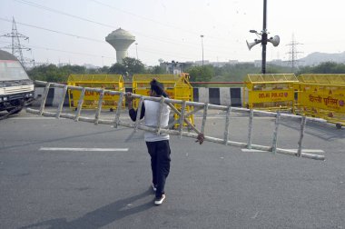 NEW DELHI INDIA FEBRUARY 11 2024 Delhi Police officials preparing security arrangements at Ghazipur Border ahead of the farmers call for March to Delhi on 13th February on February 11 2024 in New Delhi India The Delhi Chalo March organized by around  clipart