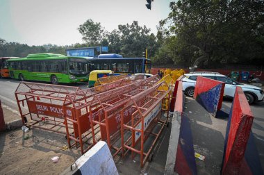 NEW DELHI INDIA FEBRUARY 14 2024 Delhi Police officials put barricades over road ahead of Delhi Chalo protest march call by farmers in punjab at Daryaganj on February 14 2024 in New Delhi India Massive deployments of police and paramilitary personnel clipart