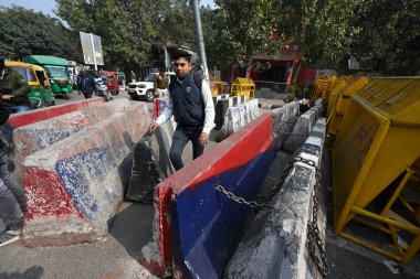 NEW DELHI INDIA FEBRUARY 14 2024 Delhi Police and other Security officials put barricades as a preventive measure after the Delhi Chalo protest call by farmers at Netaji Subhash Marg Near Red fort on February 14 2024 in New Delhi India Massive deploy clipart