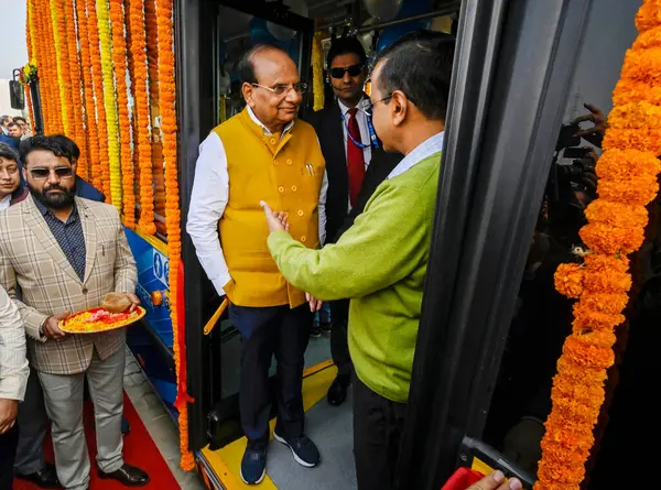 stock image NEW DELHI INDIA FEBRUARY 14 2024 Delhi LG Vinai Kumar Saxena Delhi Chief Minister Arvind Kejriwal during a function to flag off 350 DTC electric buses at Baansera in Sarai Kale Khan on February 14 2024 in New Delhi India The Delhi governments electri