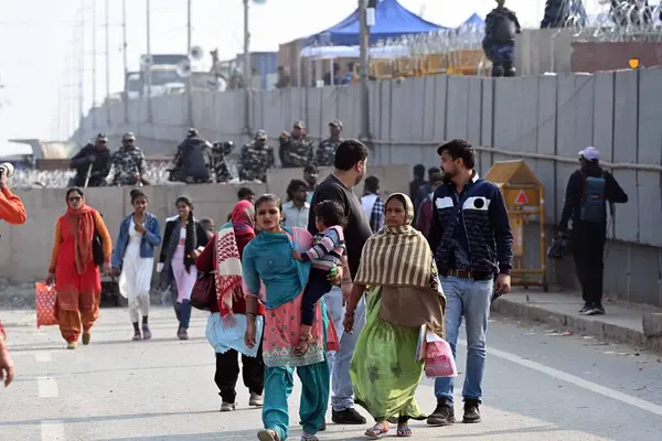 stock image NEW DELHI INDIA FEBRUARY 14 2024 People make way through barricades installed as part of security arrangements near the Singhu border in view of farmers Delhi Chalo march on February 14 2024 in New Delhi India Massive deployments of police and parami