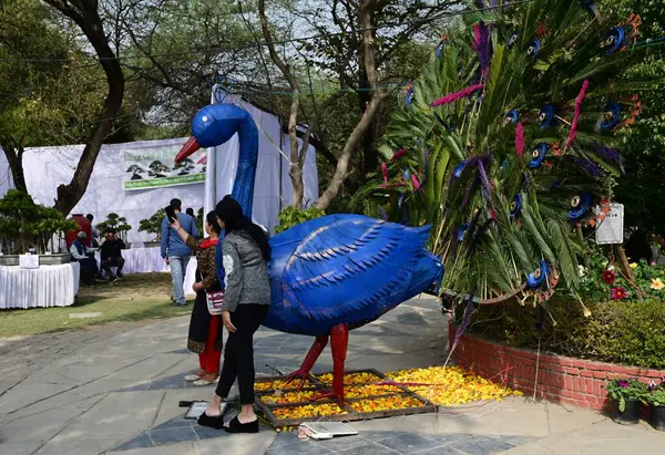 stock image NEW DELHI INDIA FEBRUARY 18 2024 Visitors take selfies and photos with flowers during the 36th Garden Tourism Festival organized by Delhi Tourism in collaboration with the Delhi Government held at Garden of Five Senses on February 18 2024 in New Delh