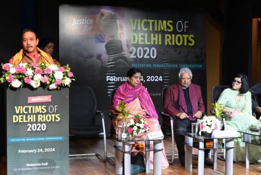 NEW DELHI INDIA FEBRUARY 24 2024 A victim Hari Nand addressing on the present Nirmal Kaur Deepak Mishra Nupur J Sharma during the fourth anniversary of the Delhi riots in 2020 a conference titled Justice for Delhi Riots 2020 2024 Prevention clipart