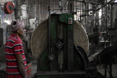 KOLKATA INDIA FEBRUARY 27 2024 Labourers work at factory section while a fire broke out at godown of Calcutta Jute Mill on February 27 2024 in Kolkata India 10 fire engine rushed to the spot and no casualties reported Photo by Samir Jana Hindustan Ti clipart