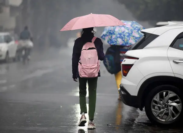 stock image NOIDA INDIA JANUARY 31 2024 Commuters during light rain in winter on January 31 2024 in Noida India There was light rain in Delhi NCR on a cold day which increased the severe cold in North India There will be light rain in DelhiNCR today According to