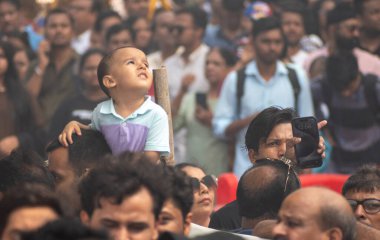 MUMBAI INDIA JANUARY 13 2024 People watching as the Indian Air force Surya Kiran aerobatics team Sarang helicopter team and Sukhoi aircraft perform during Air Show 2024 at Marine Drive The event comprises aerobatic displays by the Surya Kiran Aerobat clipart