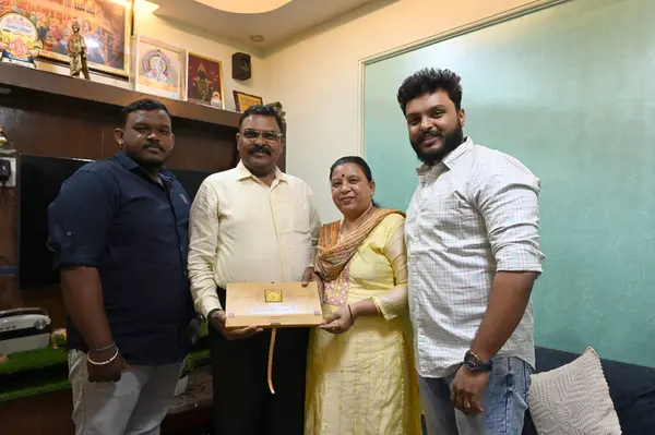 stock image NAVI MUMBAI INDIA JANUARY 19 2024 Mr Vithhal Kamble & Mrs Ujawala Kamble with sons Mihir and Aditya with invitation letter for consecration of Shri Ram Lalla idol at Ayodhya Ram Temple at Khargjhar on January 19 2024 in Navi Mumbai India 11 couples s