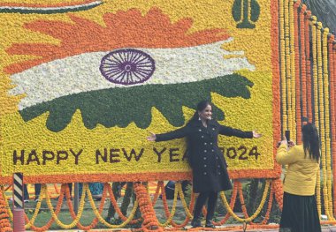 YENİ DELHI INDIA JANUARY 12024 İnsanlar Hindistan Kapısı ve Kartavaya Yolu 'nda toplanıp Vipin Kumar Hindustan Times' ın yeni yıl fotoğrafını kutlarken çiçek kalabalığı önünde selfie çekiyorlar. 
