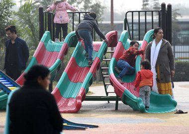 NOIDA INDIA JANUARY 7 2024 People and children during sunny hours on a cold winter day at children park in Sector 33 Foggy morning challenges Delhi NCR with intensifying cold wave mercury dips further across North India Photo by Sunil Ghosh Hindustan clipart