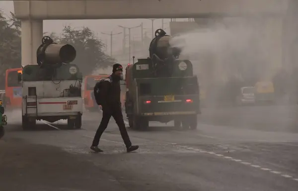 stock image NEW DELHI INDIA JANUARY 6 2024 An anti smog gun mounted on a vehicle sprays water into the atmosphere to reduce dust pollution as pollution levels risen at Anand Vihar Foggy morning challenges Delhi NCR with intensifying cold wave mercury dips furthe