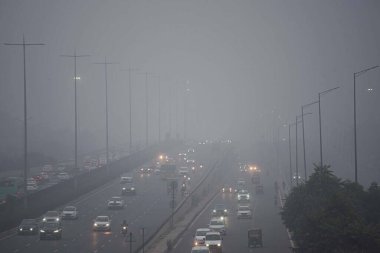 GURUGRAM INDIA JANUARY 9 2024 Commuters are traveling on the Delhi Gurugram expressway amid drizzling and low visibility on foggy cold morning near Iffoc chowk Delhi and its adjoining areas woke up to a cold and foggy morning on Tuesday and the minim clipart