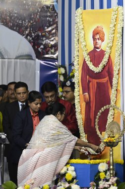 KOLKATA INDIA JANUARY 9 2024 Chief Minister of West Bengal Mamata Banerjee pays floral tribute to Swami Vivekananda and new DGP Rajeev Kumar stands behind during inauguration of the Ganga Sagar Mela Outram Ghat Transit Point before Makar Sankranti on clipart