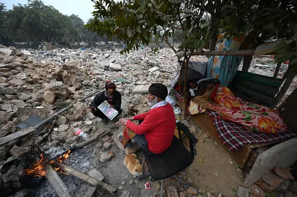 stock image NEW DELHI INDIA JANUARY 9 2024 Residents at Nizamuddin area live on the rubble that was their homes amid cold weather after MCD demolished around 300 houses near DPS Mathura road under anti encroachment drive in December Photos by Salman Ali Hindusta