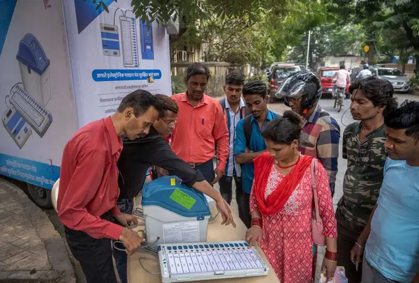 stock image MUMBAI INDIA JANUARY 9 2024 Officials on behalf of the Election Commission brief the people about the use and functions of EVM machines as part of awareness program for upcoming general elections Photo by Satish Bate Hindustan Times 