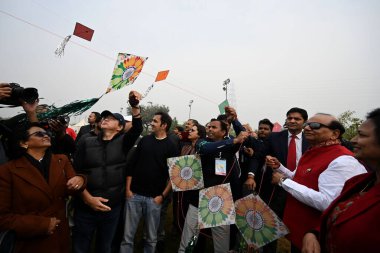 NEW DELHI INDIA JANUARY 13 2024 Delhi Lieutenant Governor VK Saxena during the first international kite festival Patang Utsav at Baansera city first bamboo theme park at Sarai Kale Khan on the banks of river Yamuna clipart