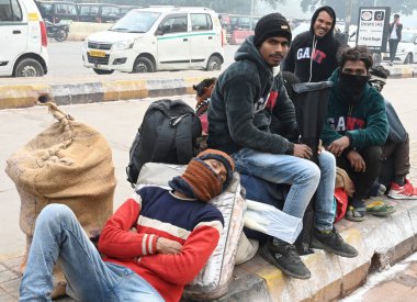 NEW DELHI INDIA JANUARY 13 2024 Passengers sit on a platform at New Delhi Railway Station several train services are impacted due to dense fog Photo by Sonu Mehta Hindustan Times  clipart