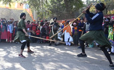 GURUGRAM INDIA JANUARY 14 2024 Young Sikh enthusiastically display their martial skills ahead of the birth anniversary of the tenth Guru Gobind Singh at new colony near police chowki Photo by Parveen Kumar Hindustan Times  clipart