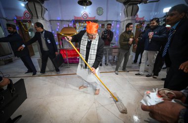 NEW DELHI INDIA JANUARY 14 2024 BJP National President J P Nadda cleans a temple to launch a week long Swachhata Drive on the occasion of Pran Pratishtha of Ram Lala at Guru Ravidas Mandir clipart