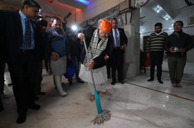 NEW DELHI INDIA JANUARY 14 2024 BJP National President J P Nadda cleans a temple to launch a week long Swachhata Drive on the occasion of Pran Pratishtha of Ram Lala at Guru Ravidas Mandir clipart