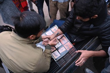 LUCKNOW INDIA JANUARY 19 2024 Ankit Vishwakarma selflessly making Lord Ram Tattoos in Lucknow Hazratganj aea free of cost ahead of consecration ceremony of Shri Ram Janmbhoomi Temple Photo by Deepak Gupta Hindustan Times  clipart