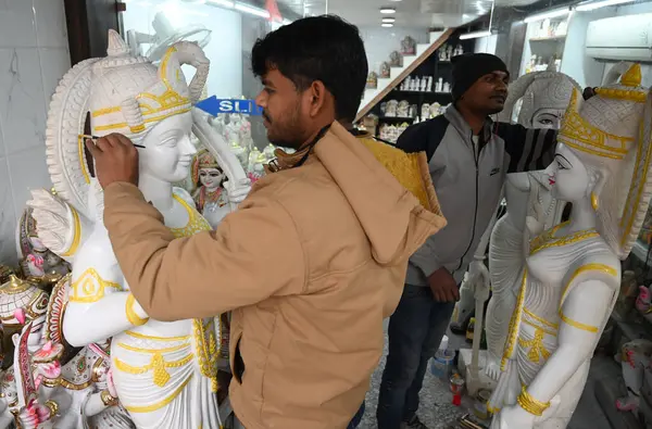 stock image NEW DELHI INDIA JANUARY 19 2024 Worker Paint a idols of Lord Ram Sita and Laxman Gods at a Shop in Qutab road Sale of Ram Darbar Murtis have gone up ahead of consecration ceremony of Shri Ram Lalla Idol at Ayodhya Temple The consecration ceremony is 