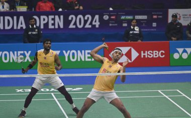 NEW DELHI INDIA JANUARY 20 2024 Satwiksairaj Rankireddy with Chirag Shetty from India competes during the Mens doubles match against Aaron Chia with Soh Wooi Yik from Malaysia at Semi Final Match of the Yonex Sunrise India Open 2024 Badminton Tournam clipart