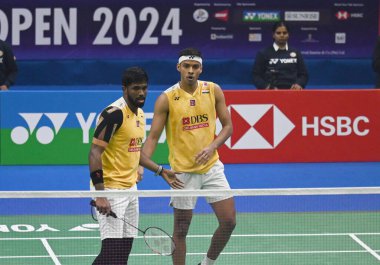 NEW DELHI INDIA JANUARY 20 2024 Satwiksairaj Rankireddy with Chirag Shetty from India competes during the Mens doubles match against Aaron Chia with Soh Wooi Yik from Malaysia at Semi Final Match of the Yonex Sunrise India Open 2024 Badminton Tournam clipart