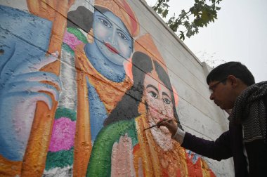 GURUGRAM INDIA JANUARY 21 2024 An 34 year old artist Jay Kumar make the mural painting of Hindu God Shri Ram and Sita ahead of Pran Prathishtha ceremony for the Ram Temple in Ayodhya at the district court parking wall near Mini Secretariat Photo by P clipart