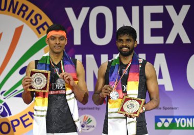 NEW DELHI INDIA JANUARY 21 2024 India Satwiksairaj Ranireddy and Chirag Shetty at the podium with thier medals after lost Men Double Final Match against Kang Min Hyuk and Seo Seung Jae from Korea for Yonex Sunrise India Open 2024 at IGI Stadium Photo clipart