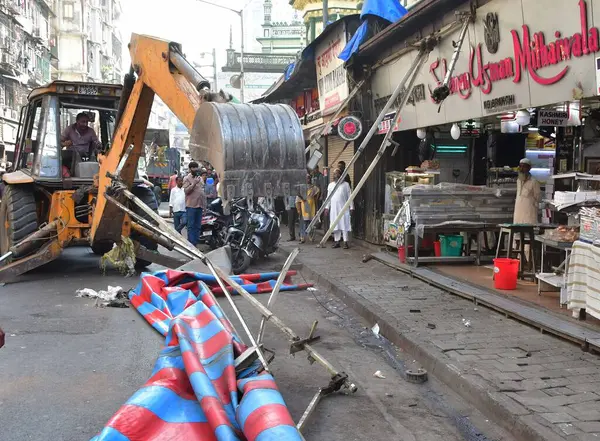 stock image MUMBAI INDIA JANUARY 24 2024 Brihanmumbai Municipal Corporation BMC brings bulldozer demolishing illegal structures that were obstructing the construction at Mohammed Ali Road near Minara Masjid Photo by Bhushan Koyande Hindustan Times 