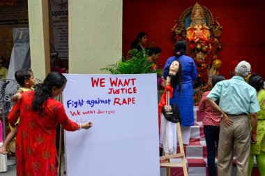 KOLKATA INDIA SEPTEMBER 7 2024 Justice for the female medic victim of RG Kar Medical College & Hospital banner and signature board are seen at a puja pandal on the occasion of Hindu deity Ganesh Chaturthi on September 7 2024 in Kolkata India Ganesh C clipart