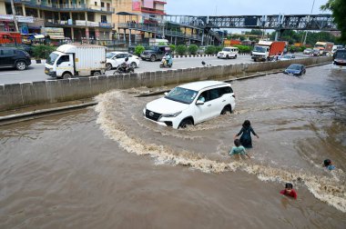 GURUGRAM INDIA SEPTEMBER 6 2024 Vehicles wade through a waterlogged stretch during heavy rain on the National Highway 48 service road near Nirsinghpur village foot over bridge on September 6 2024 in Gurugram India Several areas in the capital were af clipart