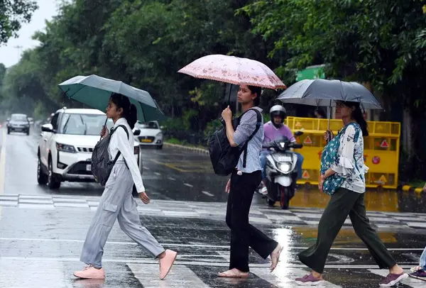 stock image NEW DELHI INDIA SEPTEMBER 4 2024 People out in the rain at Mandi House on September 4 2024 in New Delhi India Delhi residents witnessed a sudden change in weather as heavy rain lashed several parts of the city Photo by Arvind Yadav Hindustan Times