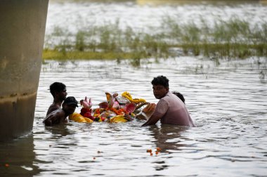 NoIDA INDIA 11 Eylül 2024 Dindarları, Ganesh Chaturthi festivalinin beşinci gününde Yamuna Nehri 'nde düzenlenen dalış töreninde toplandılar. 11 Eylül 2024 Noida Hindistan' da DPCC putların Yamuna ve oth 'a sokulmasını yasakladı.