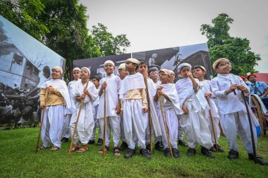 NEW DELHI INDIA SEPTEMBER 11 2024 Students dressed as Mahatma Gandhi arrives during an event of the inauguration of a Railway coach dedicated to the father of nation Mahatma Gandhi by the Union Minister of Culture and Tourism Gajendra Singh Shekhawat clipart