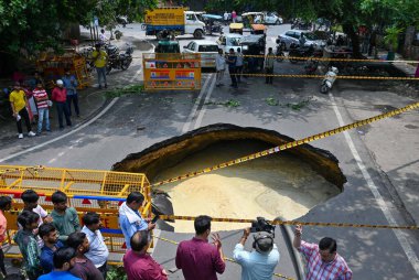 NEW DELHI INDIA JULY 5 2023 A large portion of a road in west Delhis Janakpuri caved in due to leakage of a sewer line officials said on July 5 2023 in New Delhi India The road caved in due to the leakage of a sewer line of the Delhi Jal Board Two pi clipart