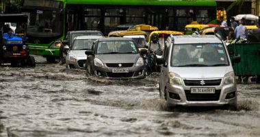 NEW DELHI INDIA JULY 8 2023 Commuters moves through a water logged street after heavy rains lashes out the city at Pandav Nagar on July 8 2023 in New Delhi India Delhi NCR was drenched with heavy rain on the intervening night of Friday and Saturday T clipart