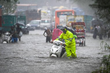 NEW DELHI INDIA JULY 8 2023 Commuters seen moving through water logged streets after heavy rainfall at Rohtak Road on July 8 2023 in New Delhi India Delhi NCR was drenched with heavy rain on the intervening night of Friday and Saturday The overnight  clipart