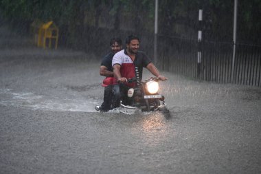 NEW DELHI INDIA JULY 9 2023 Commuters move through a water logged stretch amid heavy rains at Supreme court of India on July 9 2023 in New Delhi India Delhi NCR was drenched with heavy rain on the intervening night of Friday Saturday and Sunday The o clipart