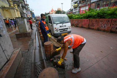 NEW DELHI INDIA - SEPTEMBER 12:  MCD workers seen cleaning the streets of Chandni Chowk  clipart