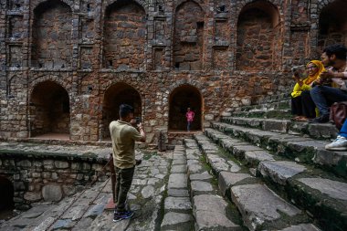 NEW DELHI INDIA - 11 Eylül 2024 'te Hindistan' ın Yeni Delhi kentinde, Connaught Place yakınlarındaki Hailey Yolu 'ndaki tarihi eser Ugrasen ki Baoli' de ziyaretçiler eğleniyor 